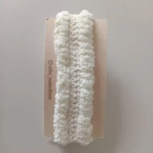 Handcrafted off-white crochet baby headband made with soft yarn, gentle and comfortable handmade accessory by Calissi